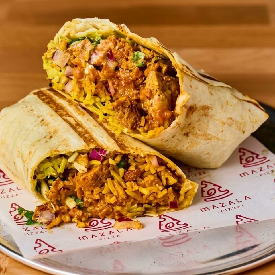 Two toasted burritos filled with seasoned rice, meat, vegetables, and sauce on a branded plate liner.